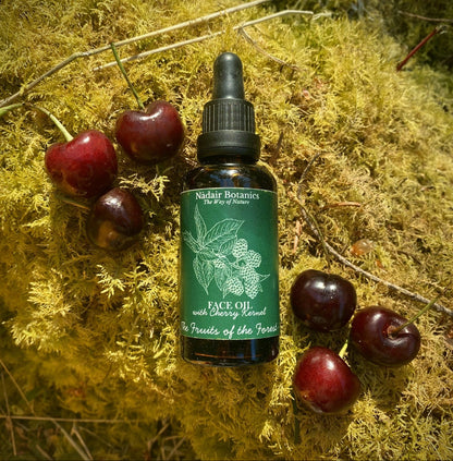 Nadair Botanics face oil bottle with cherry kernels on a moss background